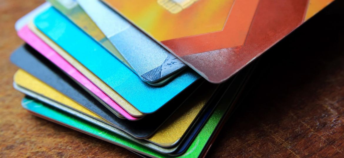 Big stack of  bright credit cards on a wooden background