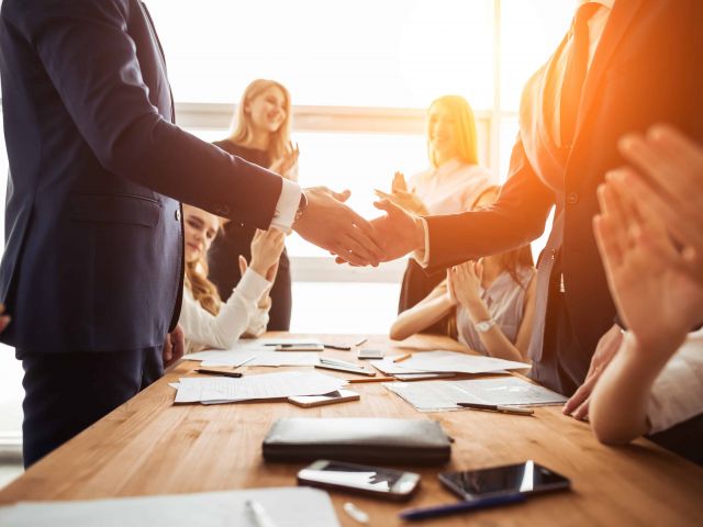 business and office concept - businessman shaking hands each oth